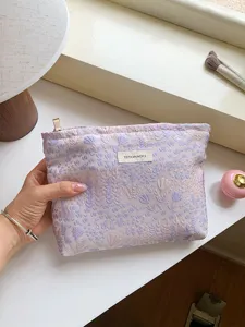 Detailed view of a stylish floral woven cosmetic bag, perfect for daily makeup storage and travel.
