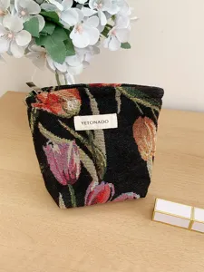 French vintage tulip jacquard cosmetic bag detail, woven floral pattern with metal zipper.