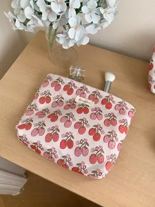 Pink strawberry print cosmetic bag detailed view, portable fabric travel makeup storage pouch.