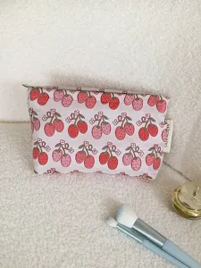 Detailed view of cute strawberry print canvas makeup pouch, ideal portable travel storage bag.
