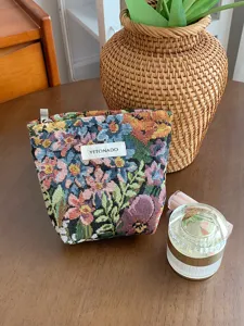 Embroidered jacquard cosmetic pouch detail, vintage floral makeup bag with zipper closure.
