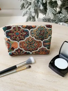 Vintage floral tapestry cosmetic bag detail, portable makeup pouch for travel and daily storage.