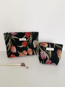 Detailed view of the vintage tulip jacquard cosmetic pouch showing the fine fabric and label.
