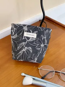 Floral canvas makeup bag for women, portable cosmetic pouch and toiletry organizer detail.