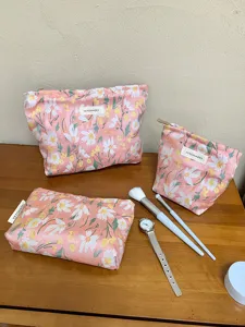 Pink floral cosmetic bag set, portable zipper storage pouch for travel and daily use.