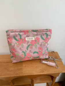 Pink floral embroidered makeup bag, portable fabric cosmetic pouch, cute travel storage case.