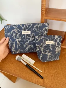 Detailed view of the stylish blue floral print cosmetic storage bag with neat stitch and zipper.