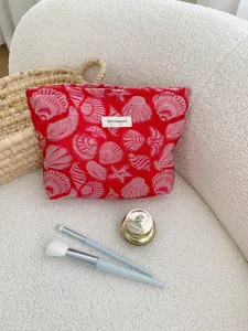 Red shell pattern cosmetic bag detail view, canvas material with large capacity and zip.
