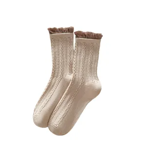 Women knit mid-tube socks with cute brown ruffled cuff and classic cable pattern for autumn.