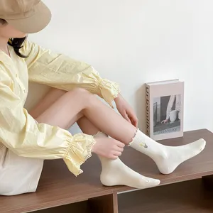 Summer cotton mid tube socks for women with cute floral embroidery and lettuce ruffle edge design.