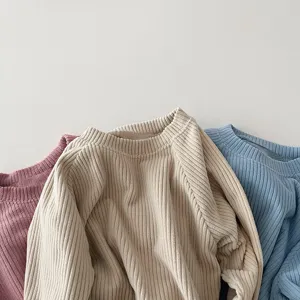 Detailed view of children's soft ribbed long-sleeve sweaters in multiple colors, cozy spring wear.