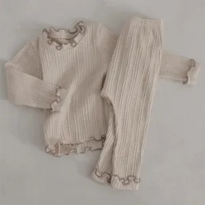 Infant ribbed cotton long sleeve top and pants set detail view, soft lettuce edge trim.