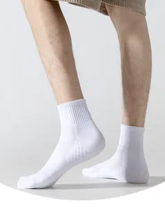Detail view of men's white athletic mid-calf socks featuring thick towel sole for sports.