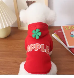 Detailed shot of a cute red pet hoodie with green flower on hood and apple lettering on back.