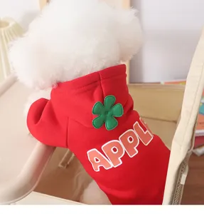 Detail view of cute red pet hoodie with green flower patch and back letter print, warm winter wear.