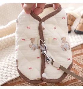 Close-up detail of the warm dog vest with cute bear pattern, soft quilted fabric and metal leash ring.