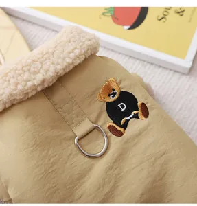 Detailed shot of pet winter warm cotton coat featuring plush sherpa collar and cute embroidered bear.
