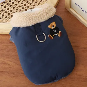 Detail shot of warm pet winter coat featuring fluffy fleece collar, metal D-ring, and cute bear embroidery.
