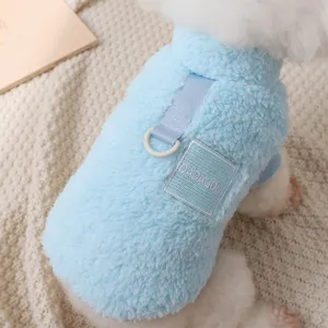 Close-up detail view of blue plush dog vest with built-in leash ring for small pets.