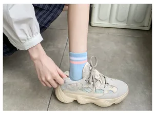 Comfortable women's short socks featuring cute two-stripe design, breathable cotton material for daily wear.