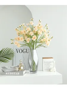 Artificial flower bouquet in glass vase, elegant faux floral arrangement for home decor.