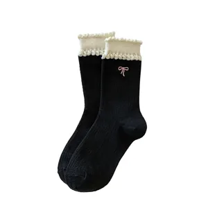 Sweet women's mid-calf socks featuring white bubble ruffle cuffs and cute pink bow embroidery.