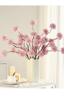 Artificial chrysanthemum flower bouquet in white ceramic vase for home decoration.