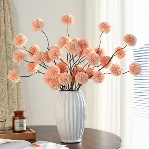 Artificial pompon chrysanthemum flowers bouquet with ceramic vase for home decor table.