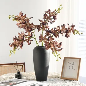 Artificial cymbidium orchid flowers in black vase retro home decor floral arrangements