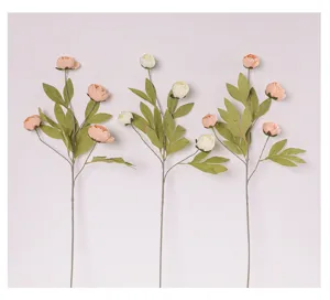 Close-up details of artificial peony flower stem with delicate petals and green leaves.