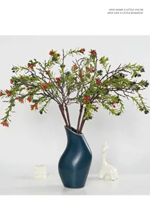 Artificial firethorn berry branch fake fruit stem with dark blue ceramic vase home decor.