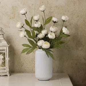 Elegant artificial peony flowers bouquet in white ribbed ceramic vase for home decor