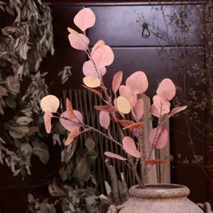 Artificial eucalyptus leaf branch detail, faux plant for vintage home decor arrangement.