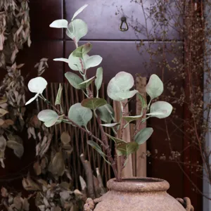 Artificial eucalyptus leaves branch detail green plant for home decor arrangement.