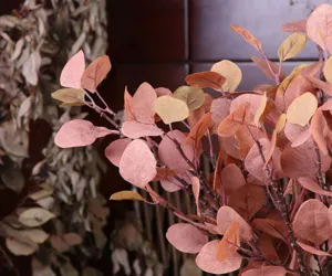 Detail shot of artificial eucalyptus leaves branch, faux greenery for floral arrangement decor.