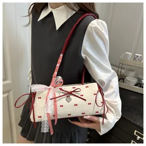 Detailed view of women underarm shoulder bag featuring sweet bow lace design and red contrast.