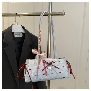 Close-up detail of cute sweet style shoulder bag with red bows, lace trim and polka dots.
