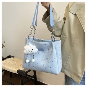 Light blue star tote bag detail, featuring silver stars, chain shoulder strap and cute cloud pendant.