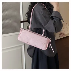 Pink cylindrical shoulder bag with star pattern, stylish commuting accessory detail view.