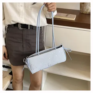 Light blue baguette shoulder bag with star pattern and cute side bow details for women.