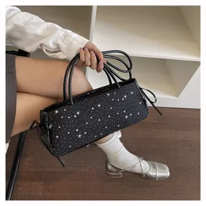 Black underarm shoulder bag detail featuring a chic white star pattern and dual top handles.