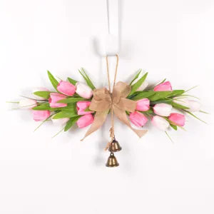 Artificial tulip door swag wreath with burlap bow and bronze bells for spring home decor.
