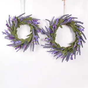 Artificial lavender wreaths detail shot, purple EVA flowers and green leaves on vine ring.