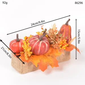 Artificial autumn pumpkin maple leaf centerpiece decoration with burlap base for thanksgiving.