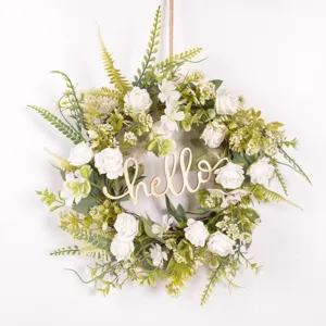 Detailed shot of artificial rose floral wreath with wooden hello text for home door wall decor.
