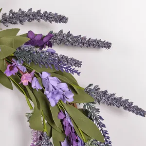 Purple artificial lavender wreath detail showing realistic EVA flowers and green leaves.