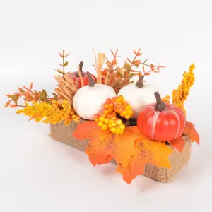 Autumn artificial pumpkin and maple leaf detail view, perfect for seasonal tabletop decor.