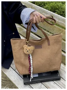 Brown large capacity tote bag with cute bear charm, stylish casual shoulder bag for women.