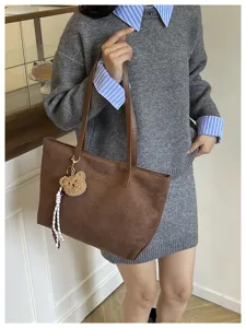 Brown suede tote bag for women, casual commuting handbag with cute bear charm and straps.