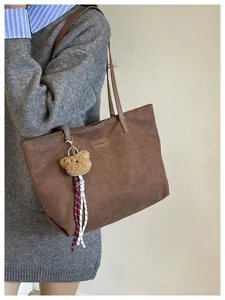 Brown suede tote bag with cute bear pendant, stylish large capacity shoulder bag for daily work.